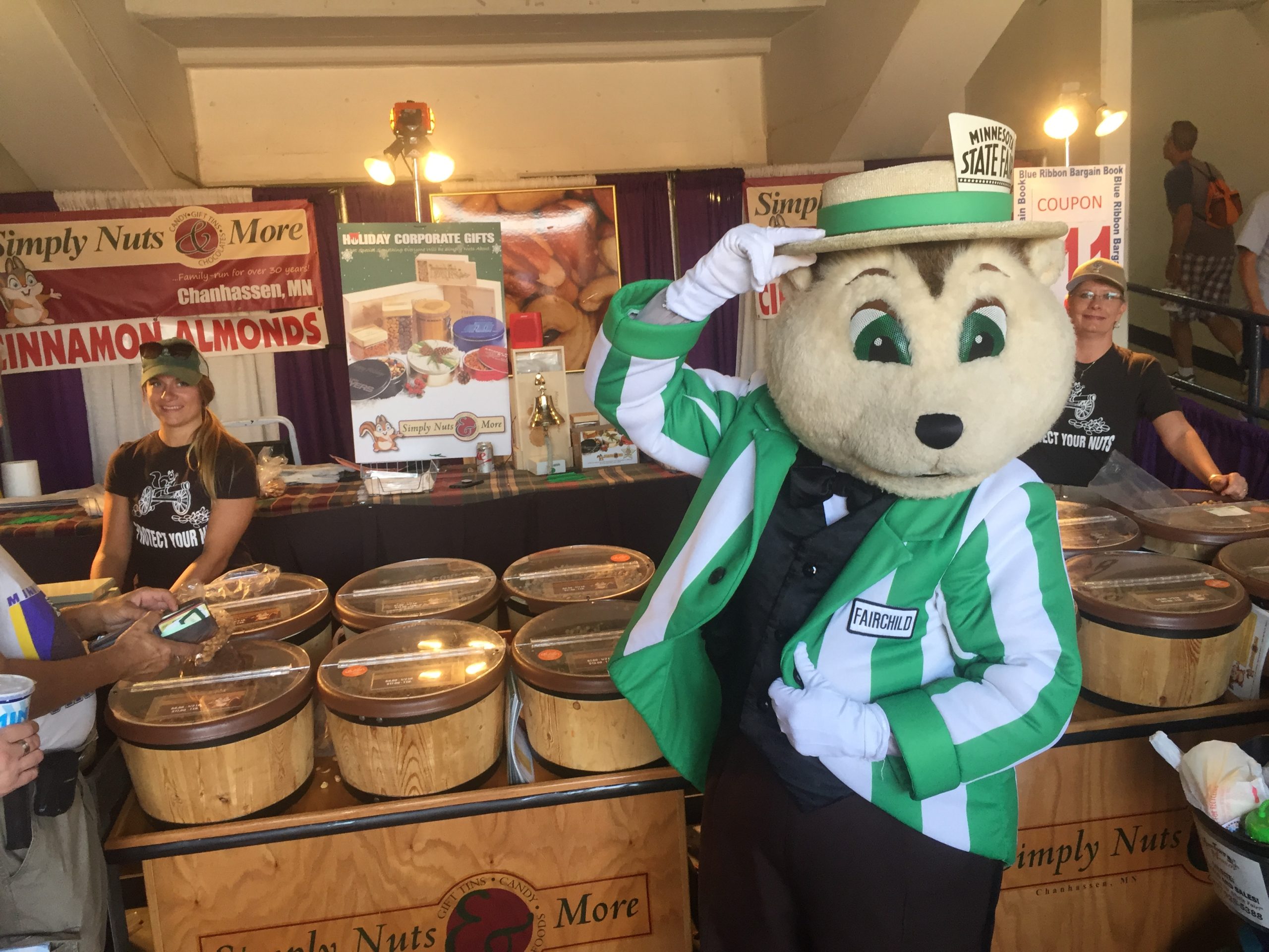 MN State Fair mascot posing at the Simply Nuts booth